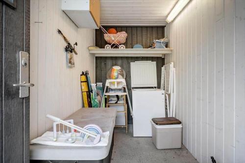 a small kitchen with a refrigerator and a table at 1102-Ringkobing-Gransangervej-14 in Nørby