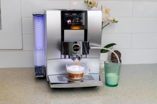 a coffee machine sitting on a counter with a cup of coffee at Secret Escape 20 Min from NYC N 1 in Jersey City