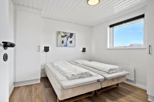 a white room with two beds in it at 2248-Ringkobing-Vestklitvej-16-A in Klegod