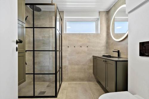 a bathroom with a shower and a sink at 2248-Ringkobing-Vestklitvej-16-A in Klegod
