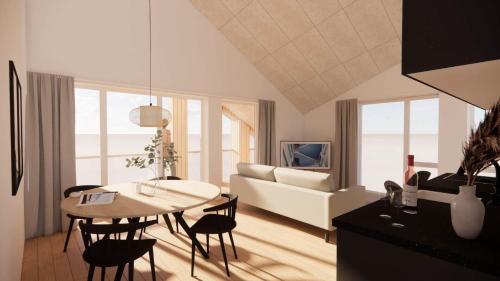 a living room with a table and a couch at 1088-Ringkobing-Badevej-17-C-1-TV in Søndervig