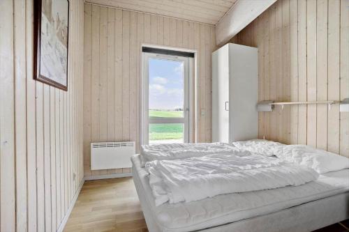 a white bedroom with a large bed and a window at FY293-Faaborg-Mosegarden-42 in Faaborg