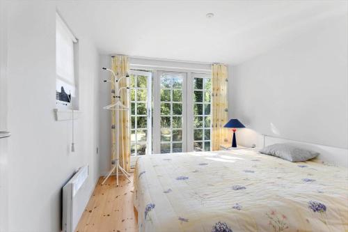 a white bedroom with a large bed and a window at FY339-Martofte-Fynshovedvej-786 in Martofte