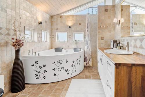 a bathroom with a tub and two sinks at FY289-Faaborg-Avernakovej-22 in Faaborg