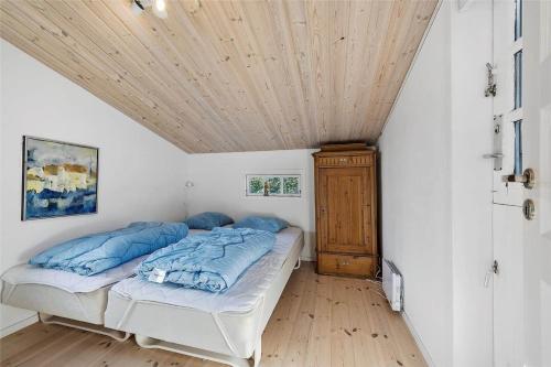 a bedroom with a bed and a wooden ceiling at FY318-Nyborg-Sommerbyen-23 in Nyborg