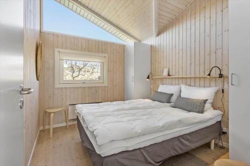 a bedroom with a large bed and a window at FY261-Ebberup-Hasselvaenget-22 in Ebberup
