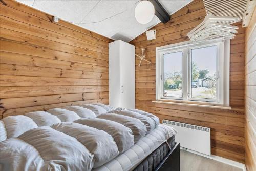 a row of pillows lined up in a room with wooden walls at FY349-Svendborg-Blaklokkevej-8 in Svendborg