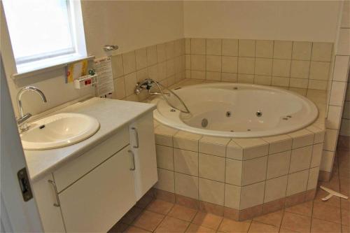 a bathroom with a tub and a sink at FY292-Faaborg-Mosegarden-40 in Faaborg