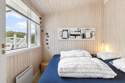 a bedroom with two beds and a window at FY100-Asperup-Bogevangsvej-4 in Asperup