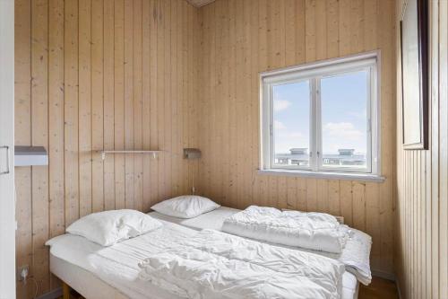 two beds in a room with a window at FY295-Faaborg-Mosegarden-39 in Faaborg