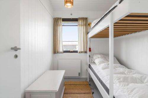 a small bedroom with a bunk bed and a staircase at FY184-Asperup-Eskelundsvej-21 in Asperup