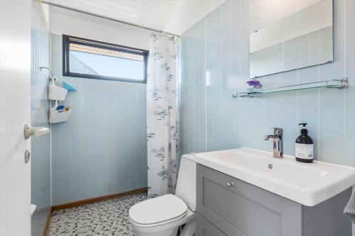 a white bathroom with a sink and a toilet at FY184-Asperup-Eskelundsvej-21 in Asperup