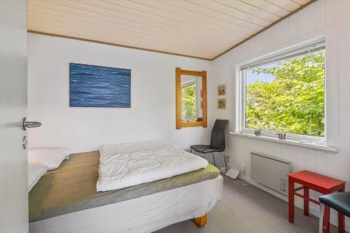 a bedroom with a bed and a window at FY155-Middelfart-Daemningen-99 in Middelfart