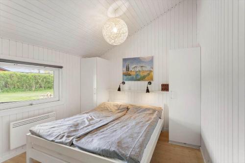 a bedroom with a bed in a room with a window at FY386-Hesselager-Stentoften-22 in Hesselager