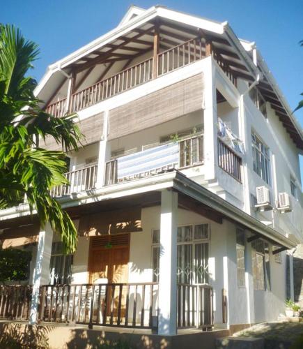 a large white building with a balcony at La Batie selfcatering Apartment in Beau Vallon