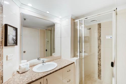 a bathroom with a sink and a shower at Aegean Apartments Surfers Paradise in Gold Coast