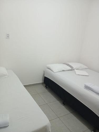 two beds sitting next to each other in a bedroom at FLAT PERTO do centro de convenções e Chevrolet Hall in Recife