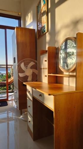 a room with a desk with a fan and a mirror at Forest Camp El Nido Extension in El Nido