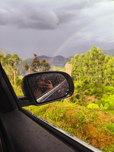 a man taking a picture in a rear view mirror of a car at CABANA SERRA DA BALANÇA in Gonçalves