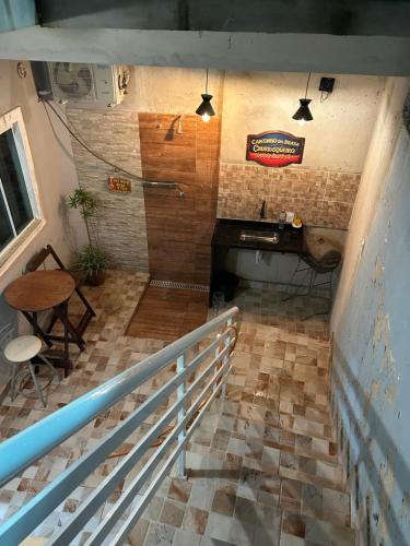 an empty room with a table and a staircase at Refúgios de Itaúna in Saquarema