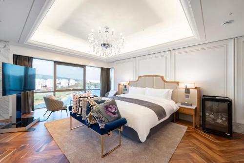 a bedroom with a large bed and a tv at Hotel Interburgo Daegu in Daegu