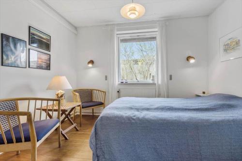 a bedroom with a bed and a table and chairs at 8592-Glesborg-Muslingevej-9 in Glesborg