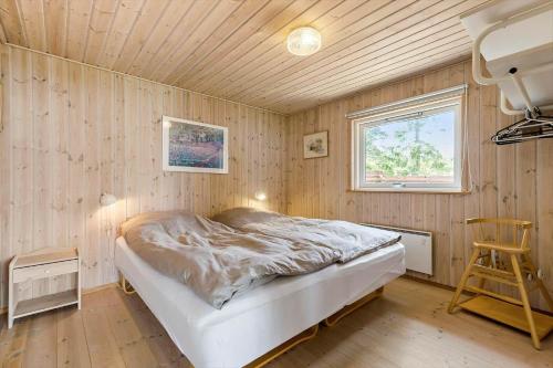 a bedroom with a bed and a wooden ceiling at 8903-Allingabro-Fyrrevej-12 in Allingåbro