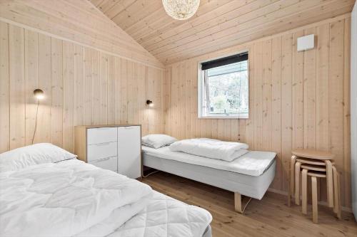 a bedroom with two beds and a window at 8995-Orsted-Alsikevej-9 in Ørsted