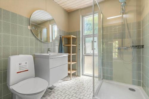 a bathroom with a toilet and a sink and a shower at 8915-Glesborg-Zachosvej-5 in Glesborg
