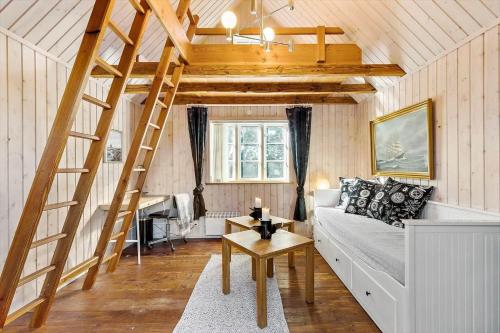 a living room with a loft bed and a ladder at 8514-Grenaa-Sortebaervej-16 in Grenå