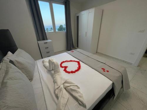 a bedroom with a bed with red flowers on it at Laguna Azul Boca Beach in Boca Chica