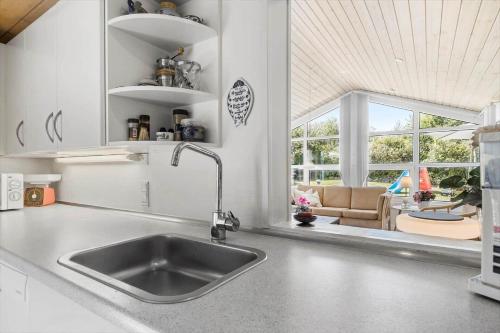 a kitchen sink with a view of a living room at 8908-Allingabro-Poppelvej-7 in Allingåbro
