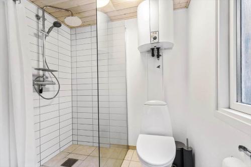 a bathroom with a toilet and a glass shower at 8963-Orsted-Spovevej-6 in Ørsted
