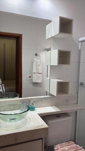 a bathroom with a glass sink and a mirror at jacuzzi e eventos em são miguel paulista in São Paulo