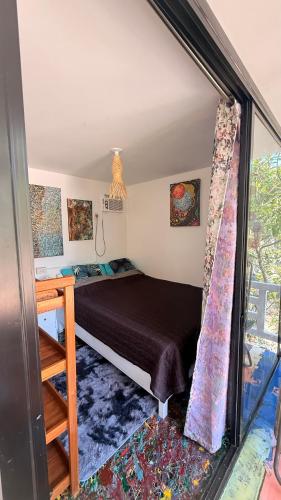a bedroom with a bed in a room with a window at Casa Alexa - Island Escape in Puerto Princesa City