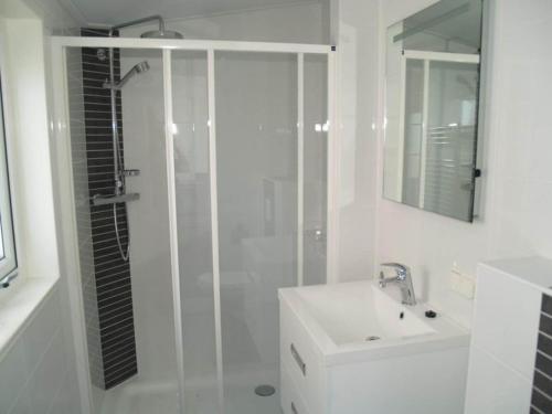 a white bathroom with a shower and a sink at Charming Chalet in De Rijp in West-Graftdijk