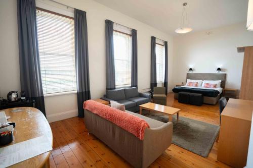a living room with a couch and a table at Park Hotel in Mount Gambier
