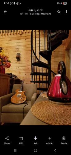 a restaurant with a guitar and a table with a telephone at Rolling Hills Lodge in Cherokee