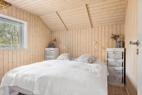 a bedroom with a white bed and a window at 84148-Ebeltoft-Sivsangervej-47 in Ebeltoft