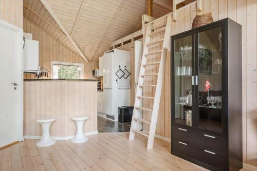a room with a kitchen and a staircase in a house at 84148-Ebeltoft-Sivsangervej-47 in Ebeltoft