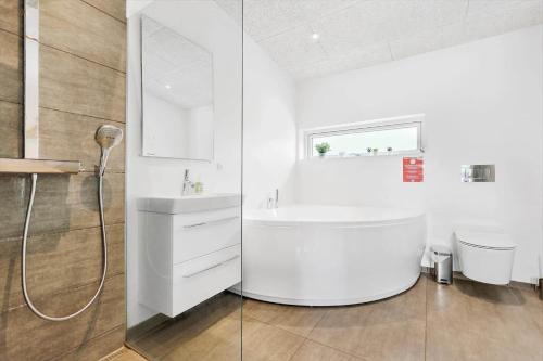 a white bathroom with a sink and a shower at 84160-Ebeltoft-Baekholmen-5-A in Ebeltoft