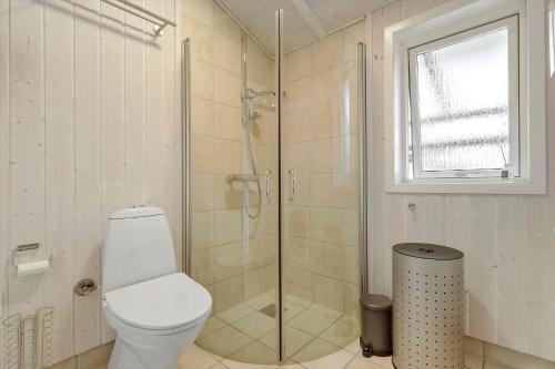 a bathroom with a toilet and a glass shower at 8014-Knebel-Rastestedet-16 in Knebel