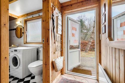 a tiny house bathroom with a washer and dryer at 8116-Ega-Under-Ronnene-37 in Egå