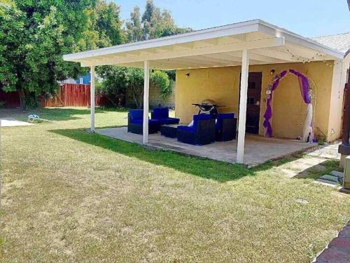 a pavilion with blue chairs and a purple arch at Large Fenced Yard, Pool Table, Disney Central in Fullerton