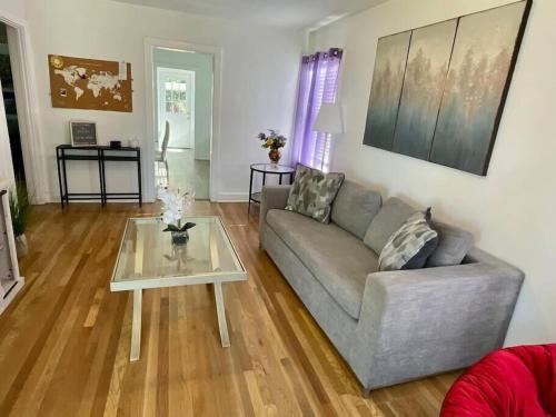 a living room with a couch and a table at Large Fenced Yard, Pool Table, Disney Central in Fullerton