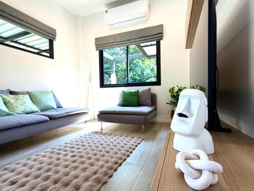 a living room with a robot in the middle of the room at AURA STAY - HeyLanna Private Family Pool Villa near Kad Farang in Chiang Mai