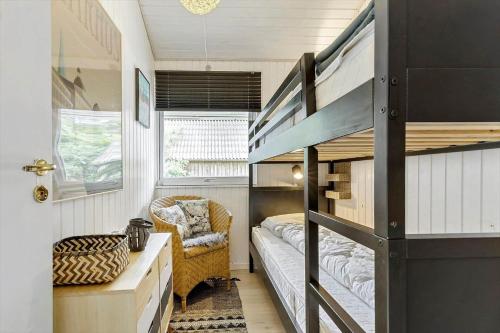 a tiny house with a bunk bed and a couch at 8211-Knebel-Basbjergvej-5 in Knebel
