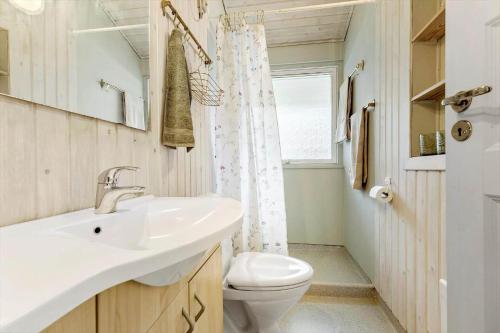 a bathroom with a white sink and a toilet at 8211-Knebel-Basbjergvej-5 in Knebel