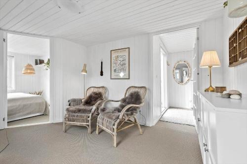 a white room with two chairs and a bed at 8113-Ronde-Strandvejen-91 in Rønde
