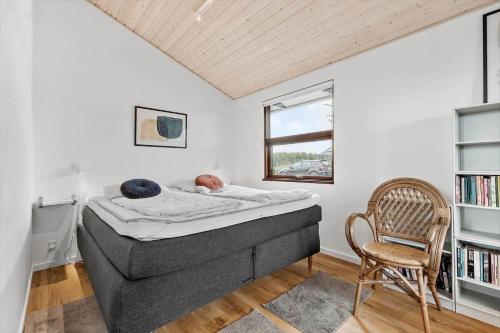 a baby laying on a bed in a room at 84164-Ronde-Stenhojvej-17 in Rønde
